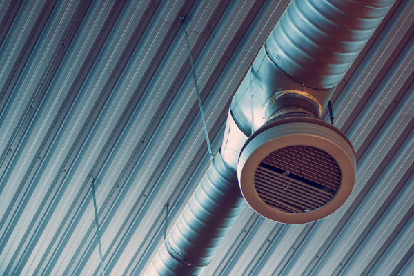 Industrial warehouse air ventilation system pipe on the ceiling